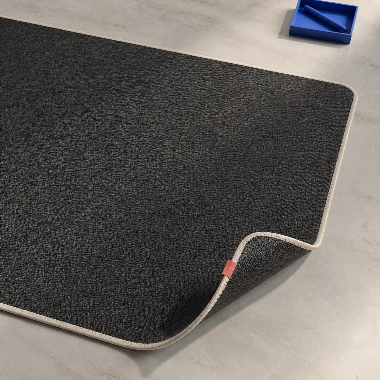 Cobalt Field desk mat with stitched coral edge