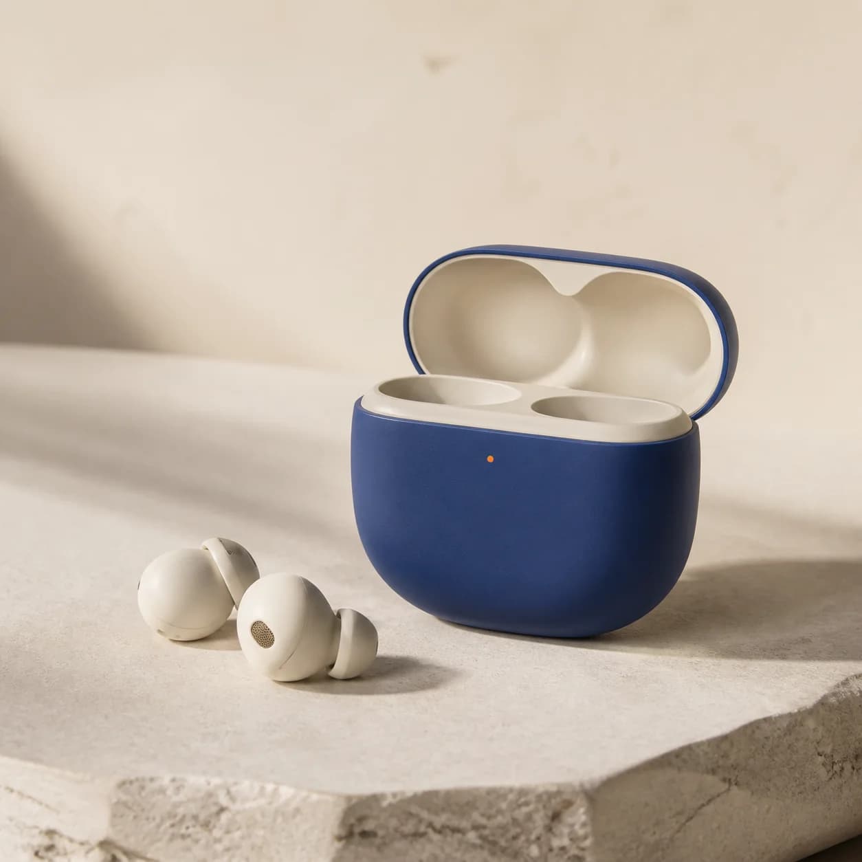 Ivory Murmur wireless earbuds in a cobalt charging case